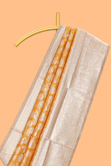 Golden yellow floral design art silk saree with contrast zari border and motifs blouse