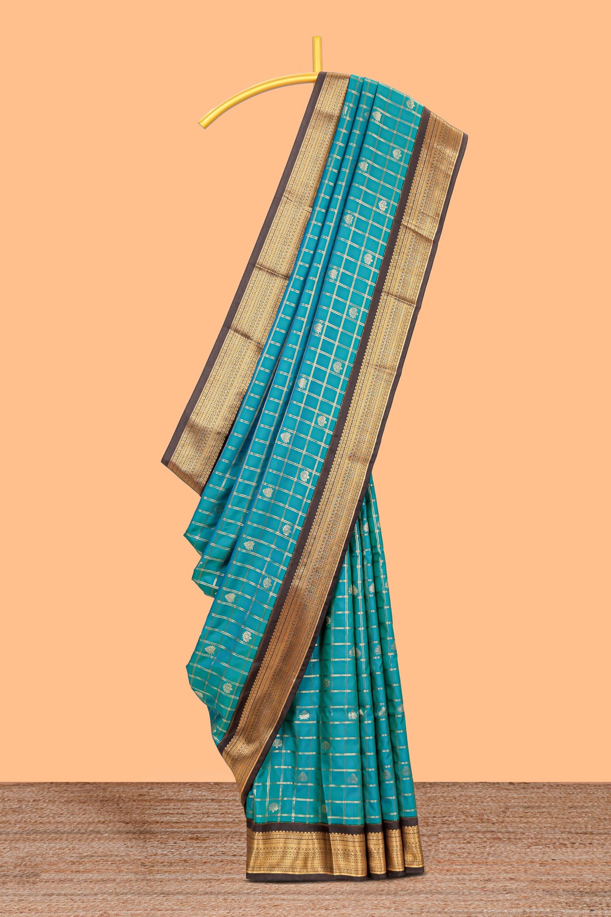 Teal blue checked art silk saree with contrast zari border and striped blouse