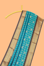 Teal blue checked art silk saree with contrast zari border and striped blouse