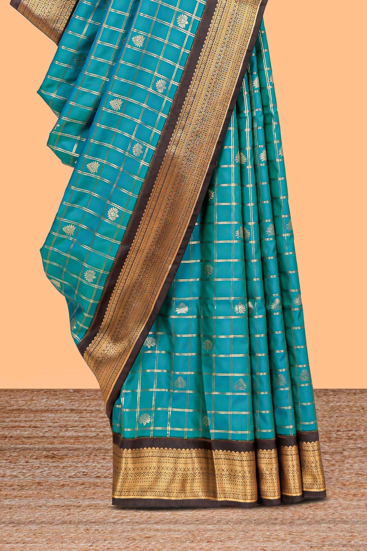 Teal blue checked art silk saree with contrast zari border and striped blouse
