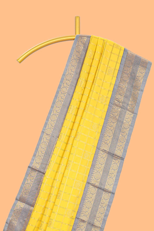 Yellow checked art silk saree with contrast zari border and blouse