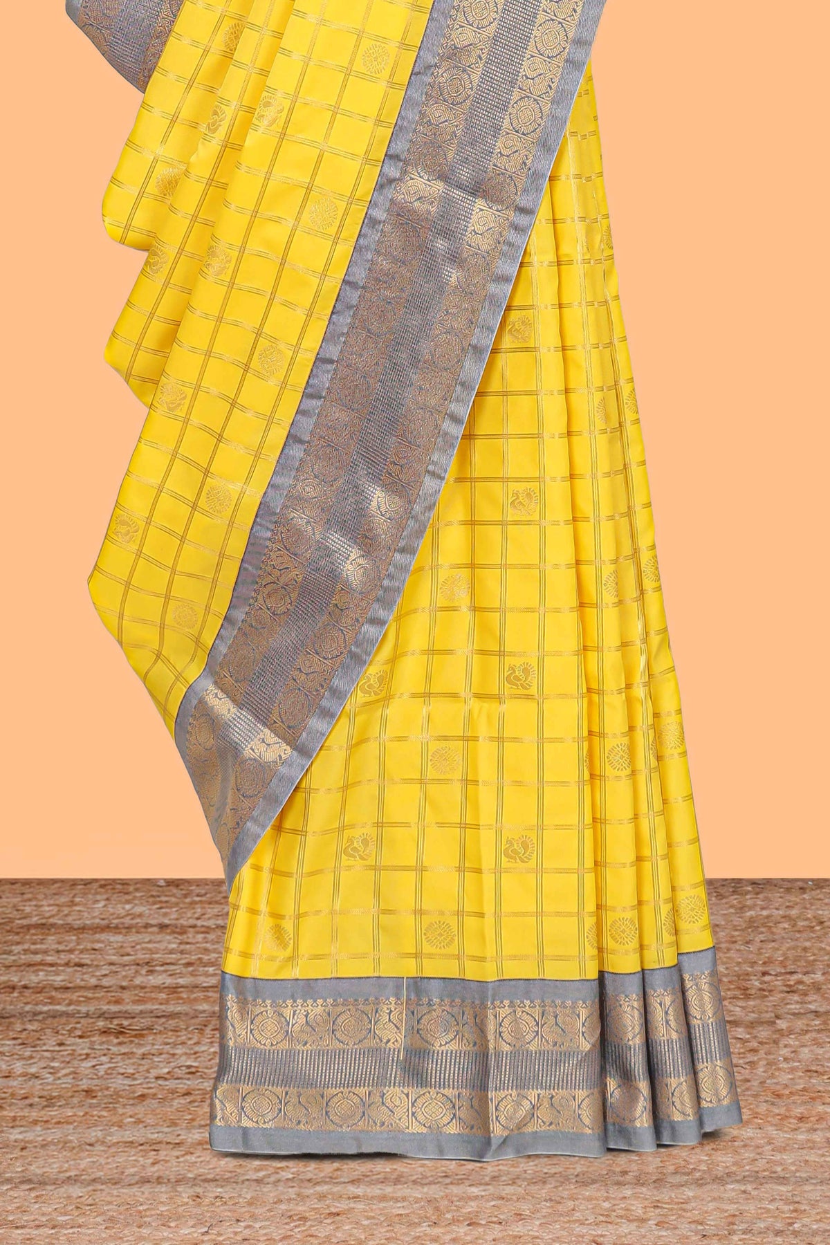 Yellow checked art silk saree with contrast zari border and blouse