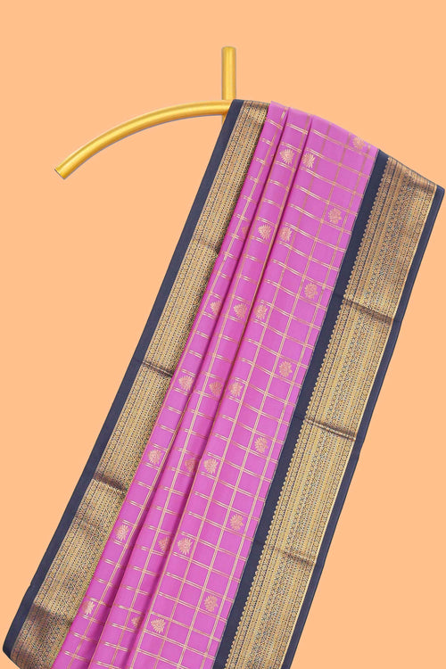 Pink checked art silk saree with contrast zari border and blouse