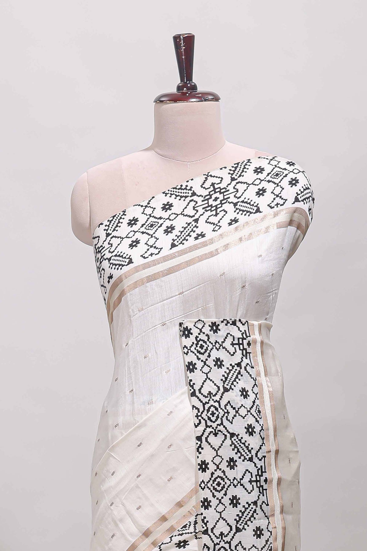 White plain assam silk saree eith self ikkat style border and matching blouse