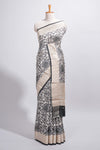 Elegant ivory Assam Silk saree with grey floral motifs detailed zari border and a contrast pallu along with contrast blouse