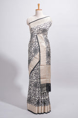 Elegant ivory Assam Silk saree with grey floral motifs detailed zari border and a contrast pallu along with contrast blouse