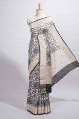 Elegant ivory Assam Silk saree with grey floral motifs detailed zari border and a contrast pallu along with contrast blouse