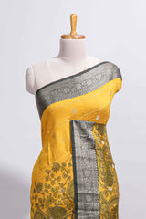 Mustard yellow Assam Silk saree floral and paisley motifs with a rich grey zari border and contrast pallu along with matching blouse