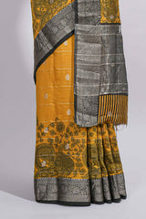 Mustard yellow Assam Silk saree floral and paisley motifs with a rich grey zari border and contrast pallu along with matching blouse