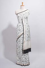 Elegant white Assam Silk saree traditional folk motif print floral patterns and a contrast black woven border The detailed pallu along with contrast blouse