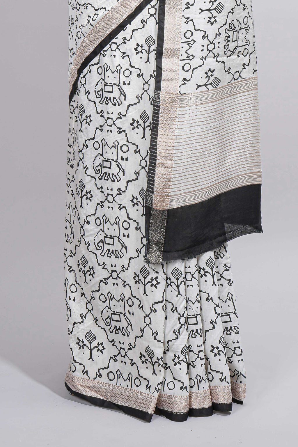 Elegant white Assam Silk saree traditional folk motif print floral patterns and a contrast black woven border The detailed pallu along with contrast blouse