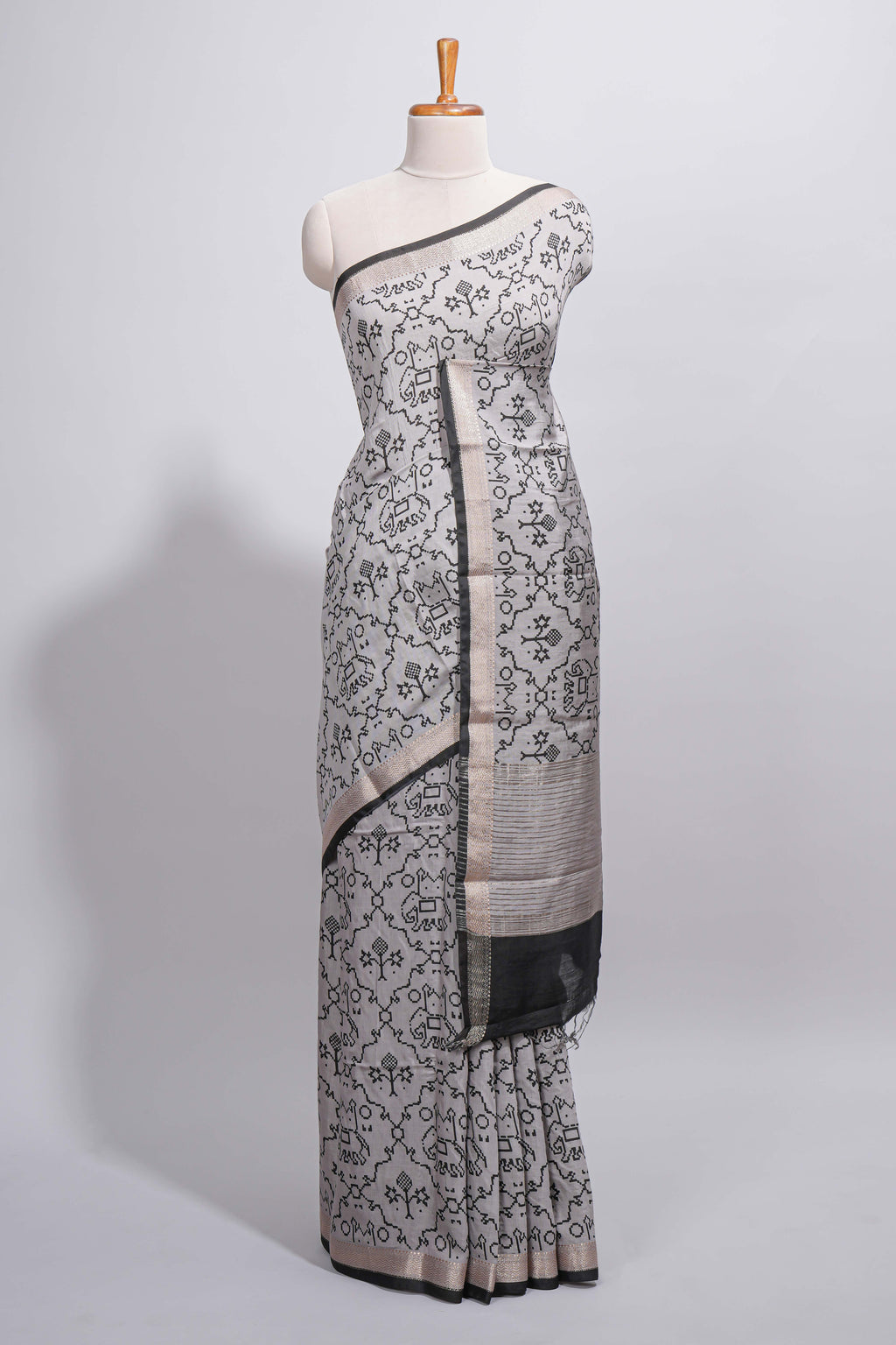 Grey colour Assam Silk saree traditional folk motif print floral patterns and a contrast woven border The detailed pallu along with contrast blouse
