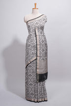 Grey colour Assam Silk saree traditional folk motif print floral patterns and a contrast woven border The detailed pallu along with contrast blouse
