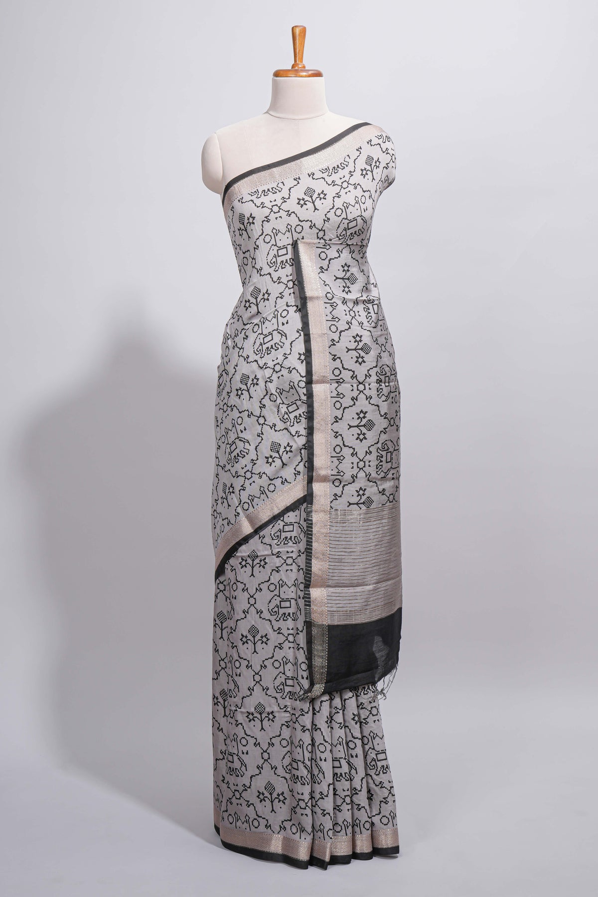 Grey colour Assam Silk saree traditional folk motif print floral patterns and a contrast woven border The detailed pallu along with contrast blouse