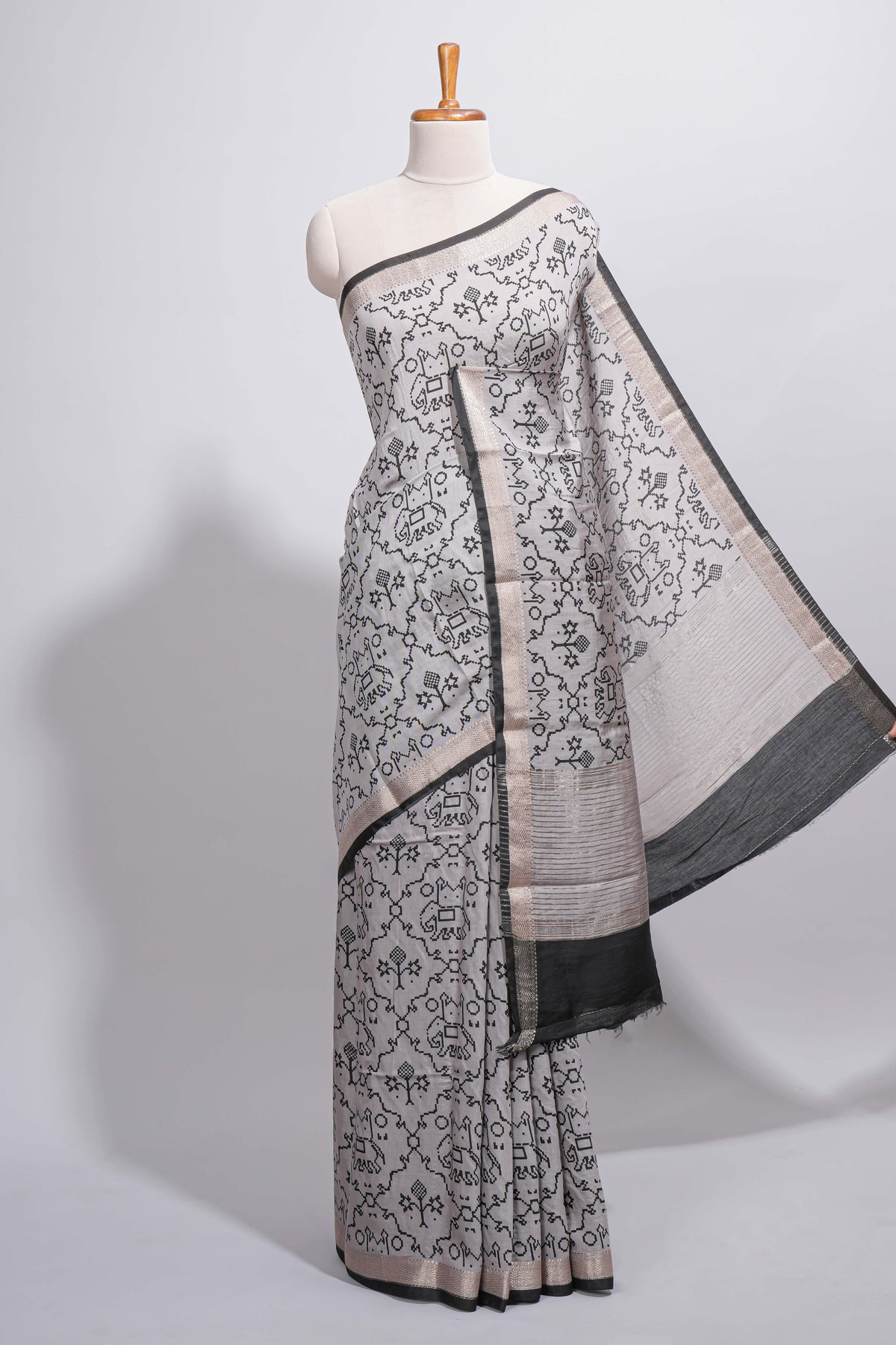Grey colour Assam Silk saree traditional folk motif print floral patterns and a contrast woven border The detailed pallu along with contrast blouse