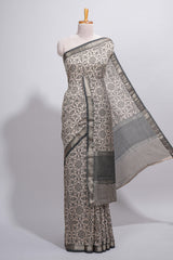Ivory colour Assam Silk saree traditional folk motif print floral patterns and a contrast woven border The detailed pallu along with contrast blouse