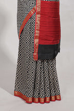 Grey geometric print  assam silk saree with  zari border and matching blouse