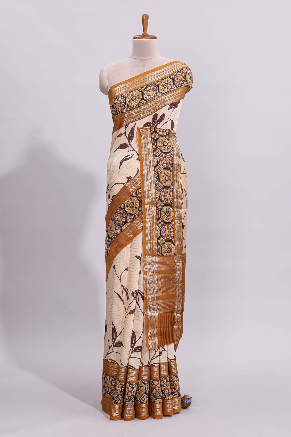 Cream floral design zari striped assam silk saree with contrast zari border and printed blouse