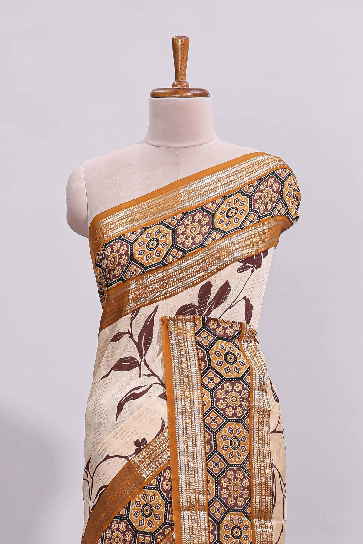 Cream floral design zari striped assam silk saree with contrast zari border and printed blouse