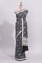 Black ikkat style floral design assam silk saree with self zari border and matching motifs blouse