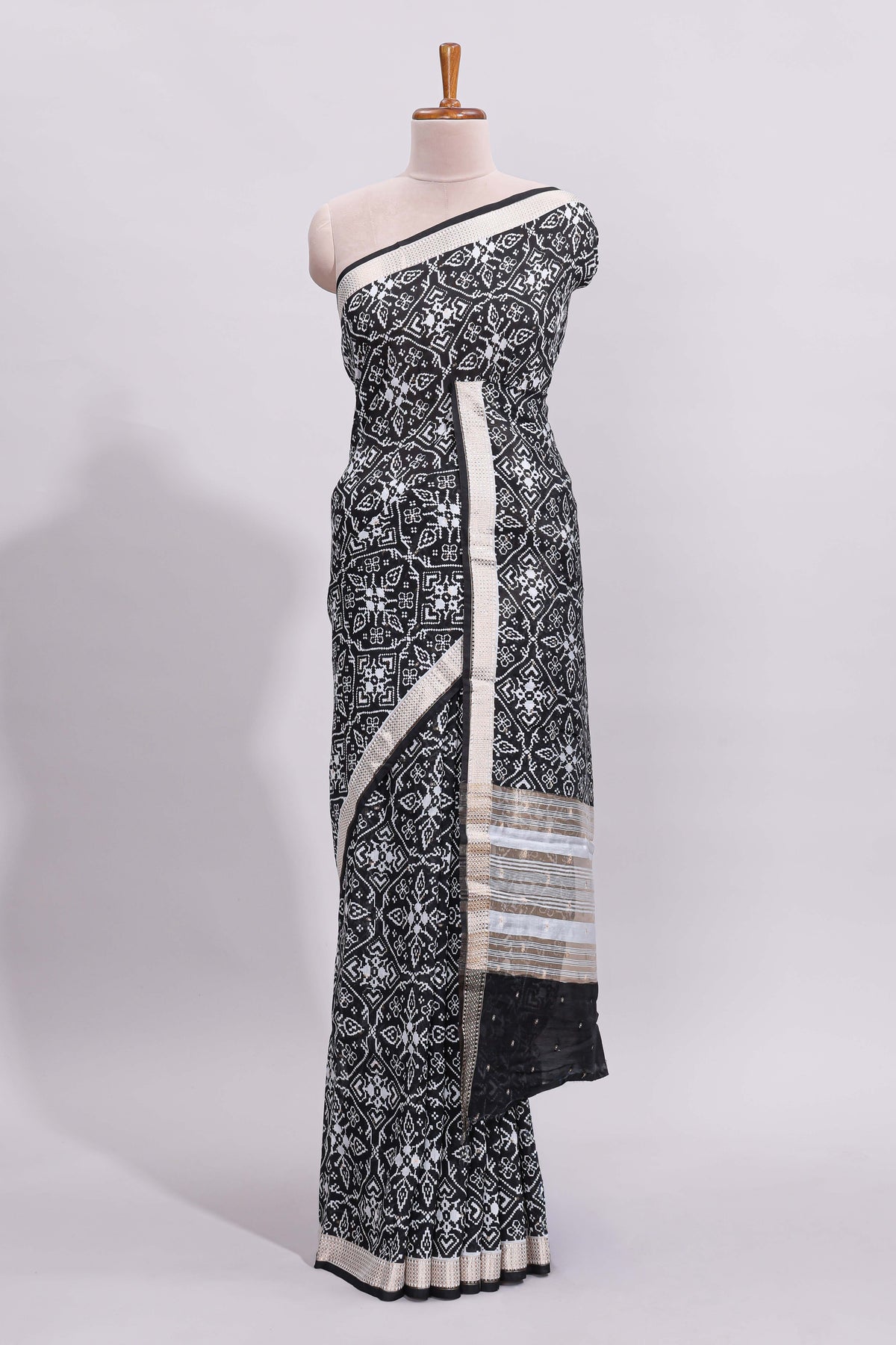 Black ikkat style floral design assam silk saree with self zari border and matching motifs blouse
