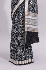 Black ikkat style floral design assam silk saree with self zari border and matching motifs blouse