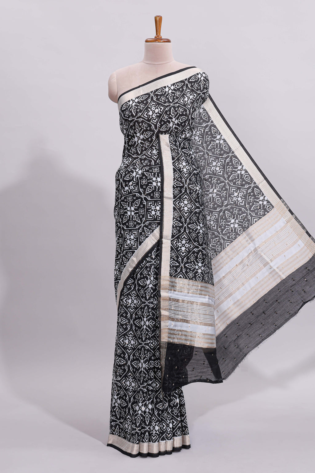 Black ikkat style floral design assam silk saree with self zari border and matching motifs blouse