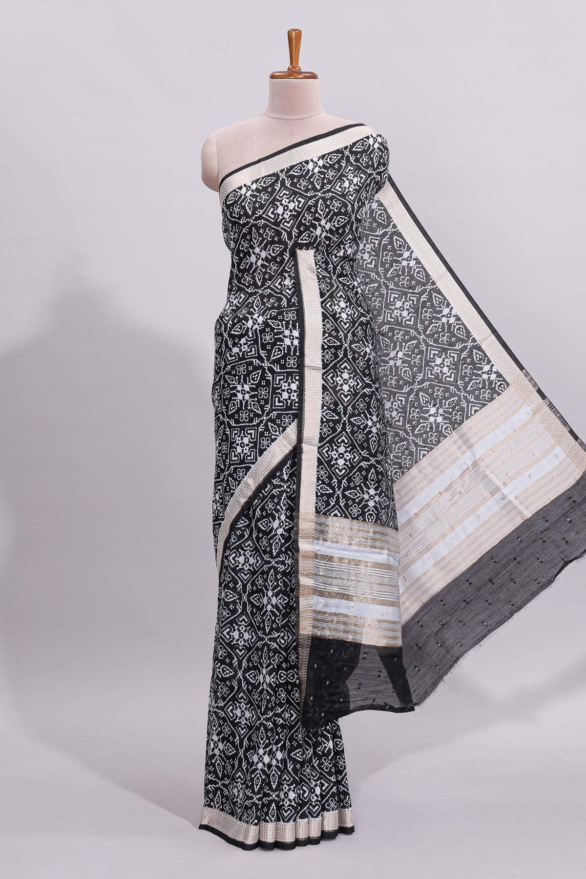 Black ikkat style floral design assam silk saree with self zari border and matching motifs blouse