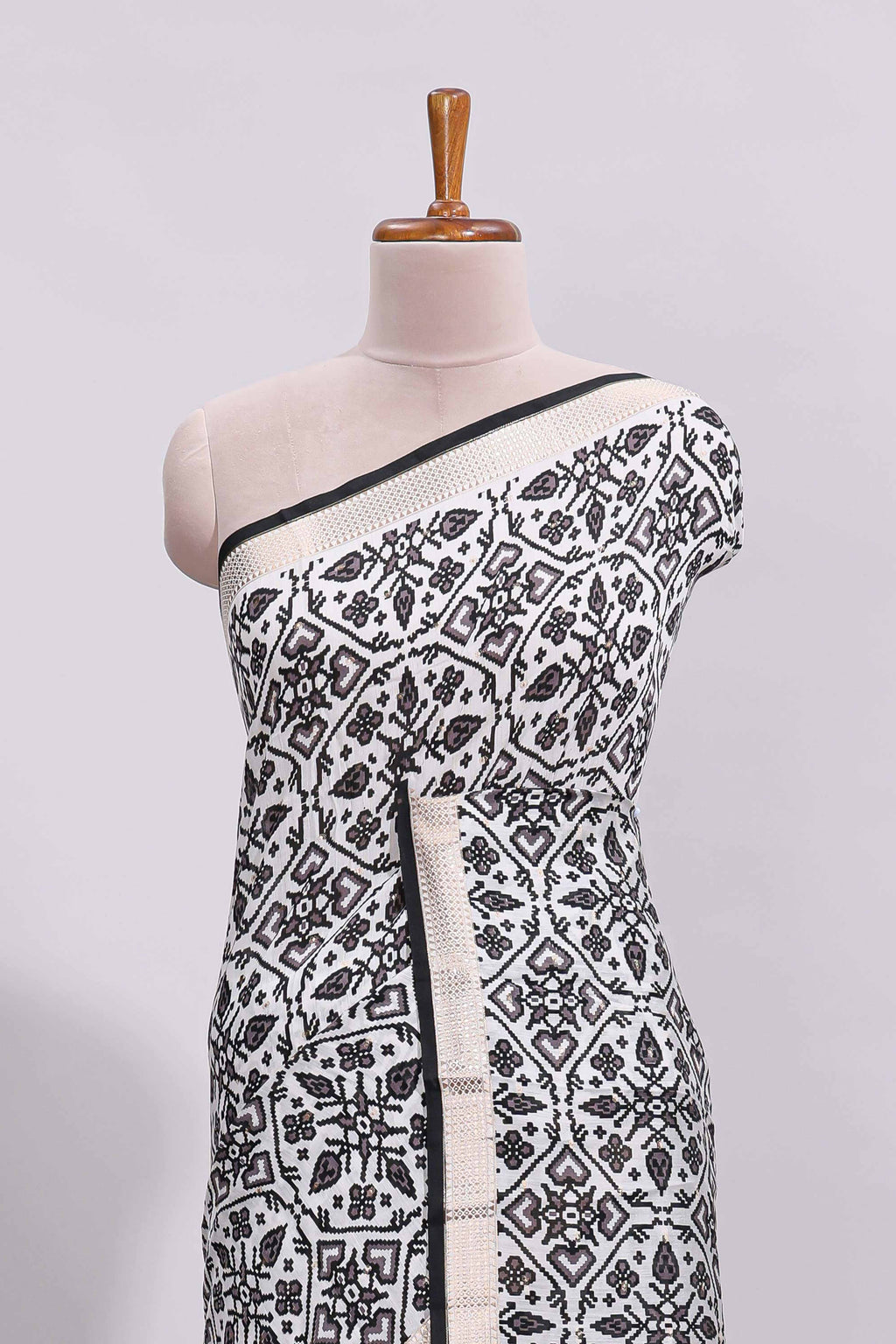 White ikkat style floral design assam silk saree with contrast zari border and motifs blouse