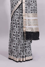 White ikkat style floral design assam silk saree with contrast zari border and motifs blouse