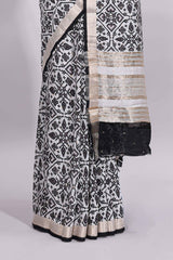White ikkat style floral design assam silk saree with contrast zari border and motifs blouse