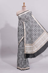 White ikkat style floral design assam silk saree with contrast zari border and motifs blouse