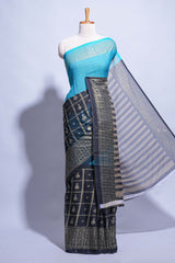 Blue color budget silk saree with contrast foil print border and contrast pallu along with contrast blouse piece