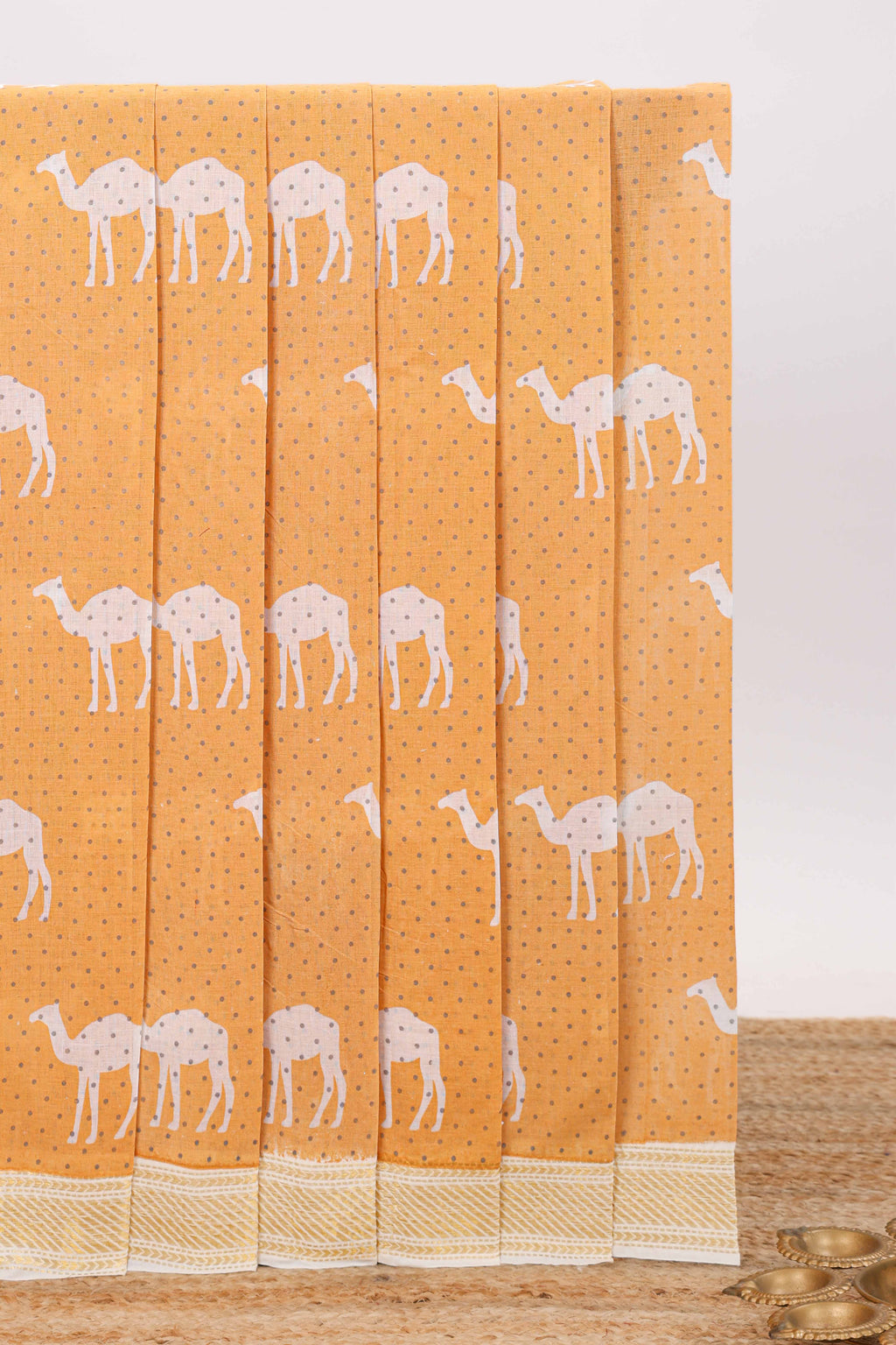 Orange camel motif chirala cotton saree with contrast zari border and blouse