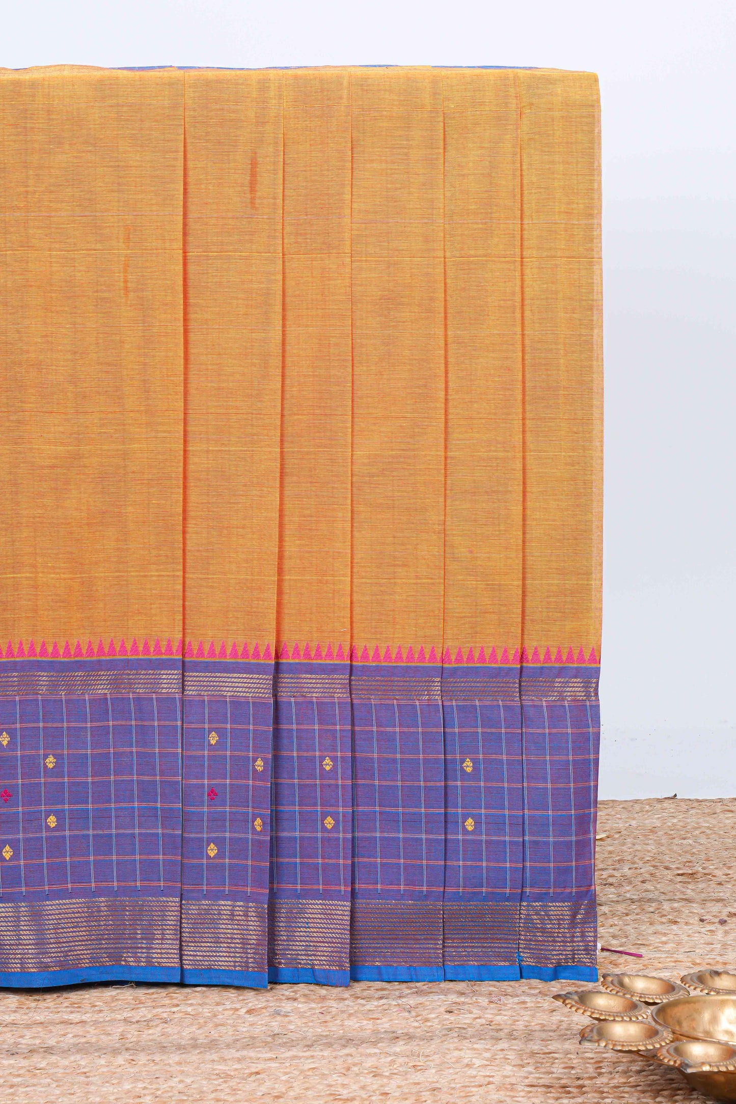 Orange plain chettinad cotton saree with contrast checked border and matching striped pallu