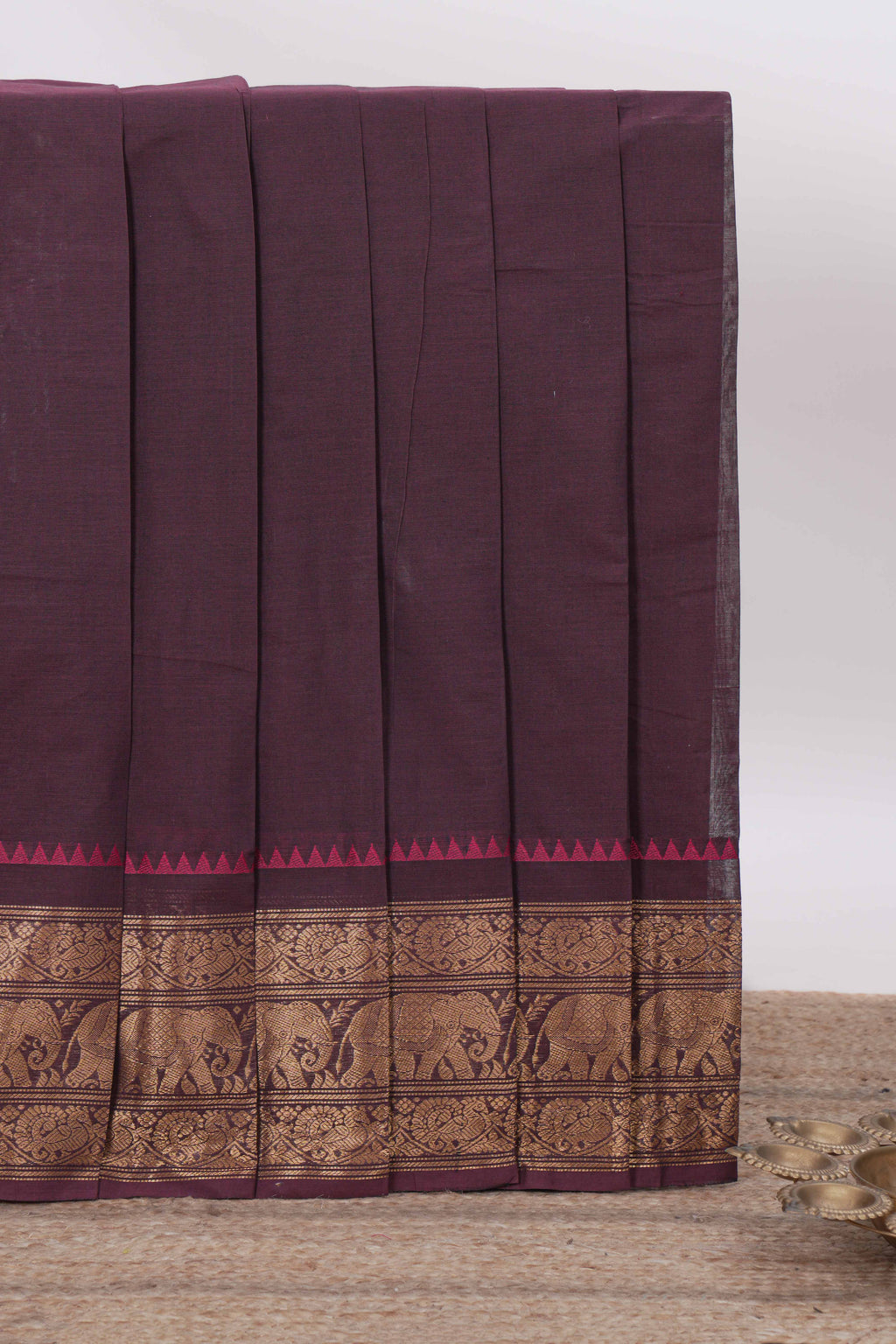 Dark Plum Chettinad cotton saree with a plain body antique gold zari elephant border along with matching blouse