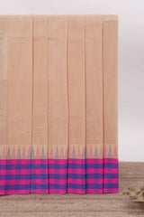 Cream Chettinad cotton saree with a plain body contrasting pink and royal blue checked border and classic temple motif detailing along with matching blouse