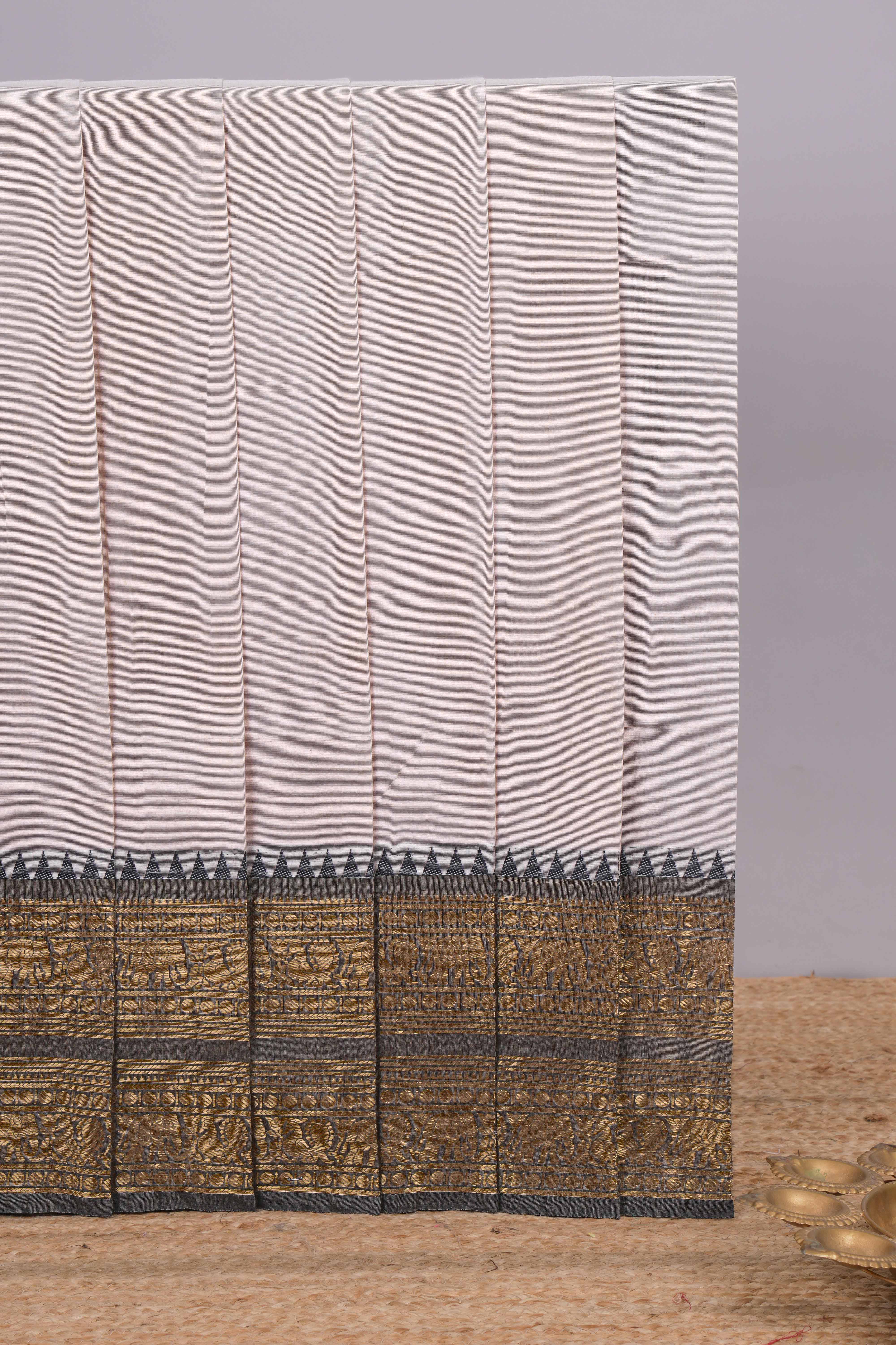 Grey plain chettinad cotton saree with contrast zari border and matching blouse