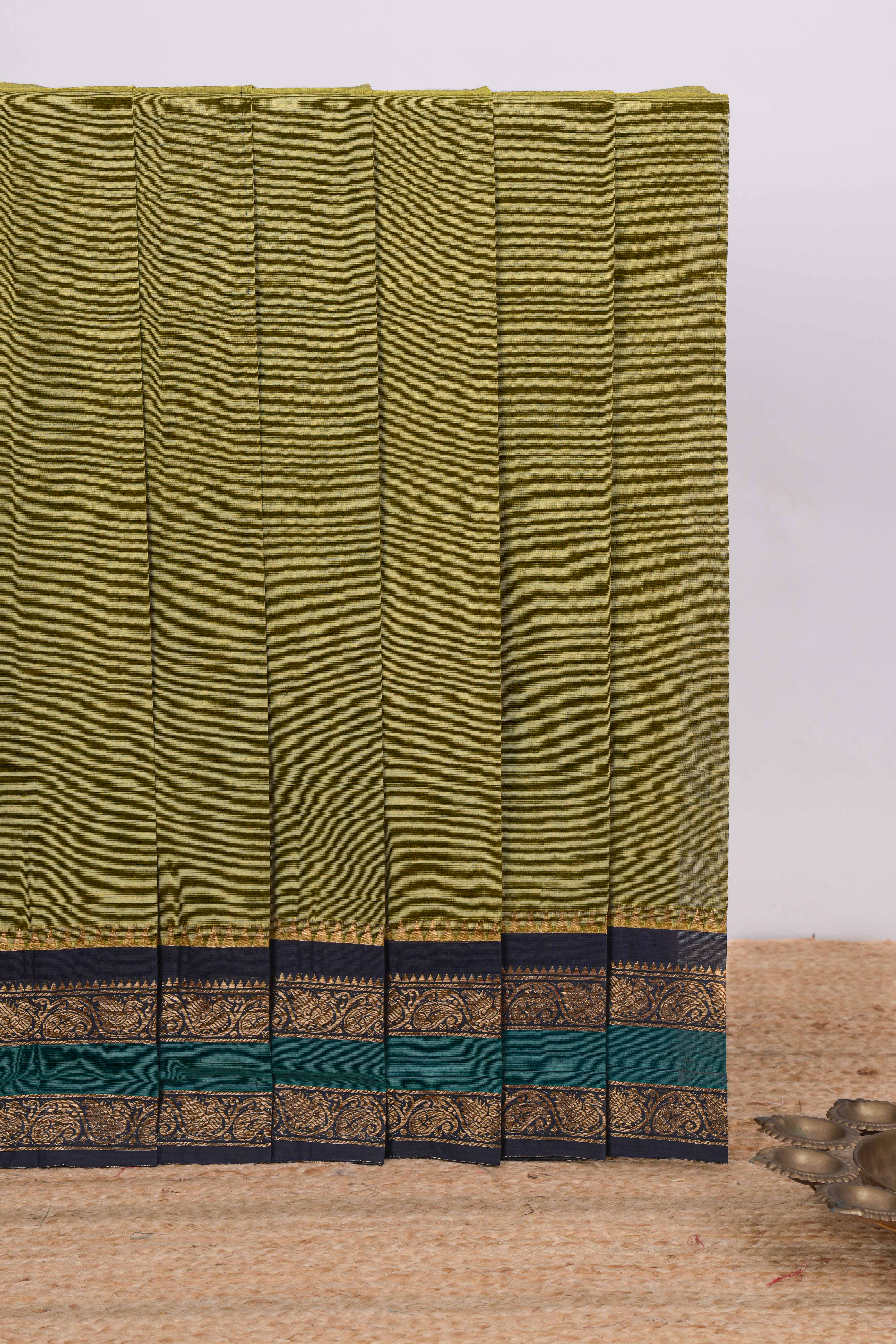 Green plain chettinad cotton saree with contrast zari border and matching blouse