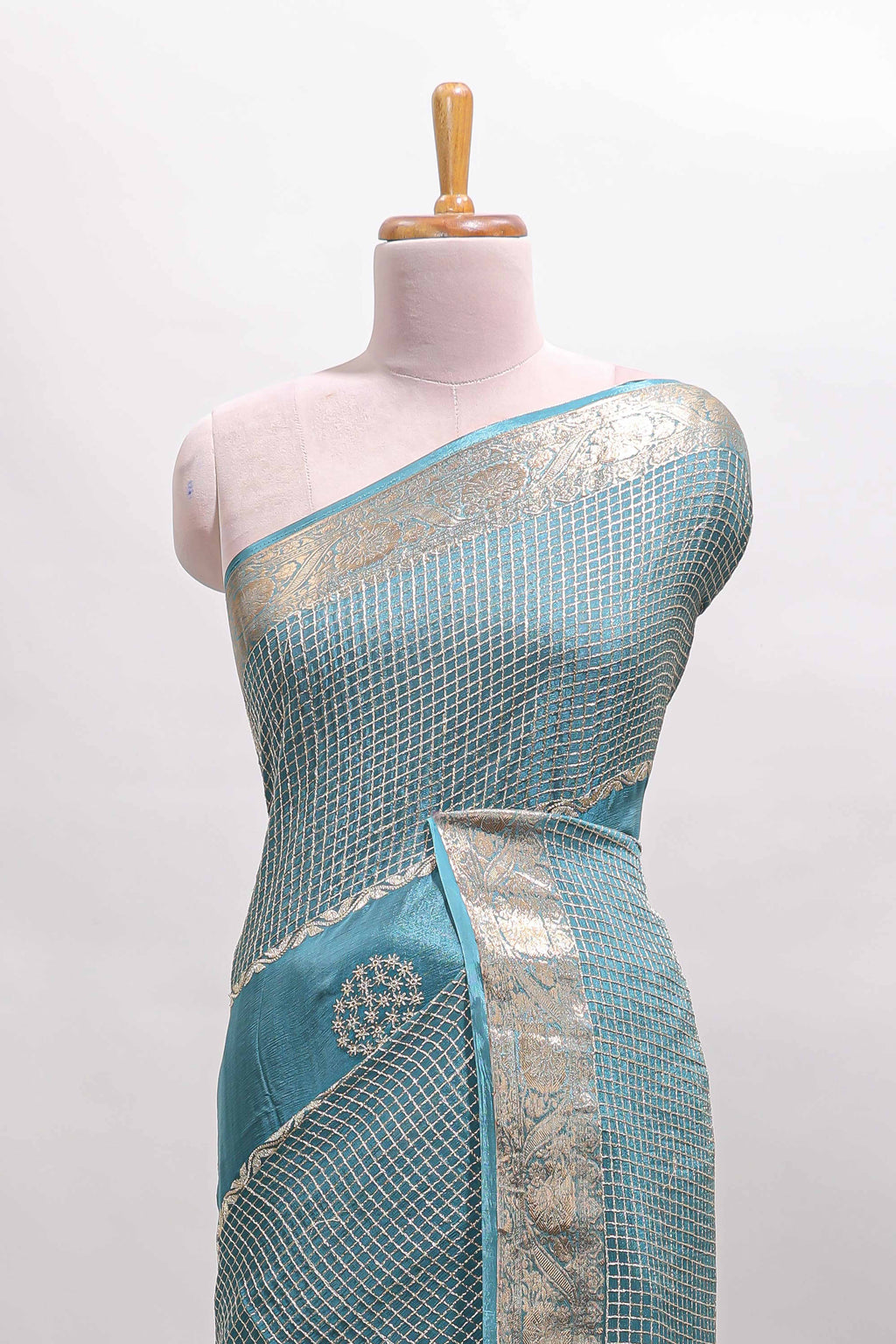 Turquoise blue checked floral motifs chiffon saree with self zari border and contrast blouse