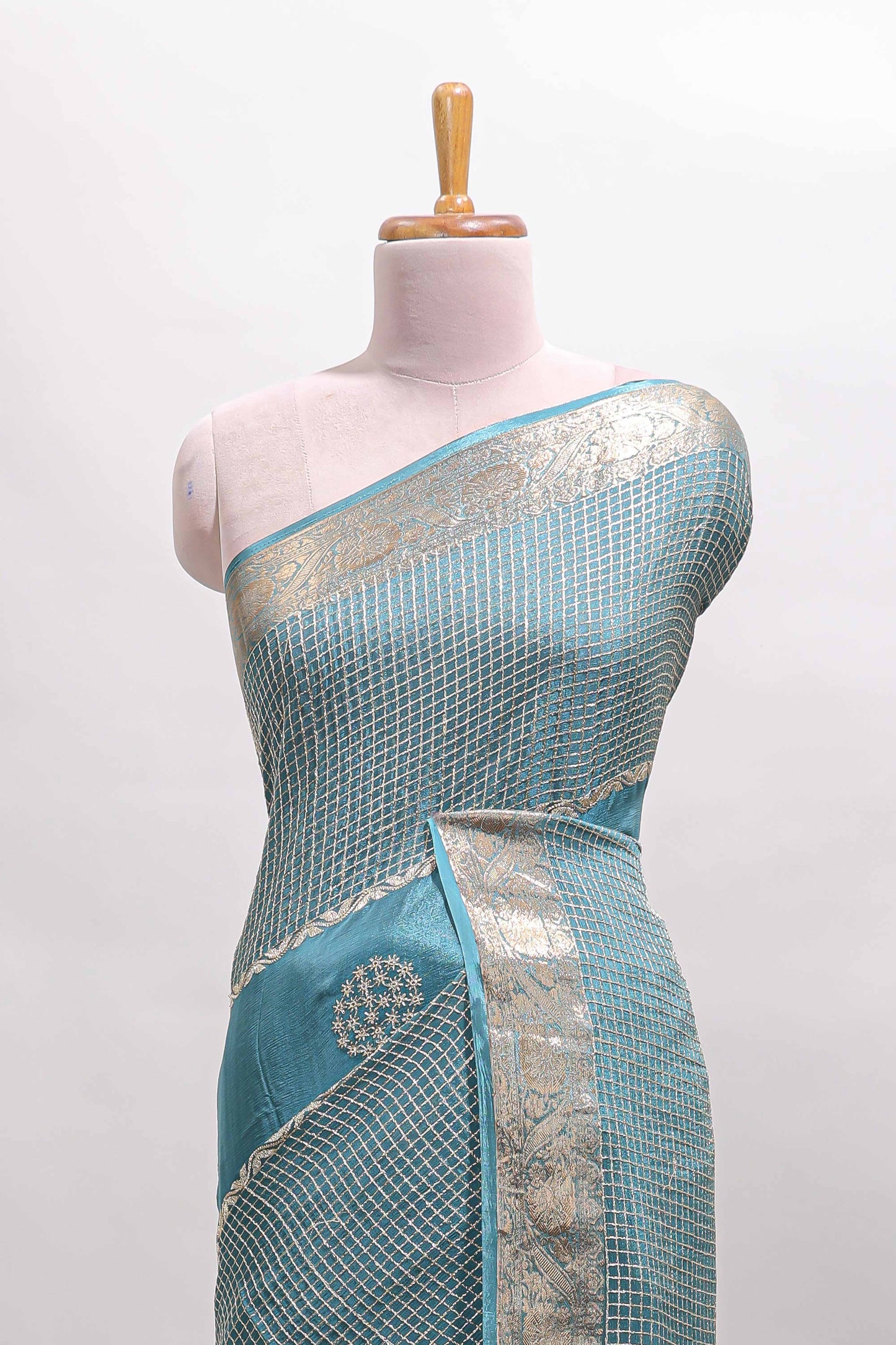 Turquoise blue checked floral motifs chiffon saree with self zari border and contrast blouse