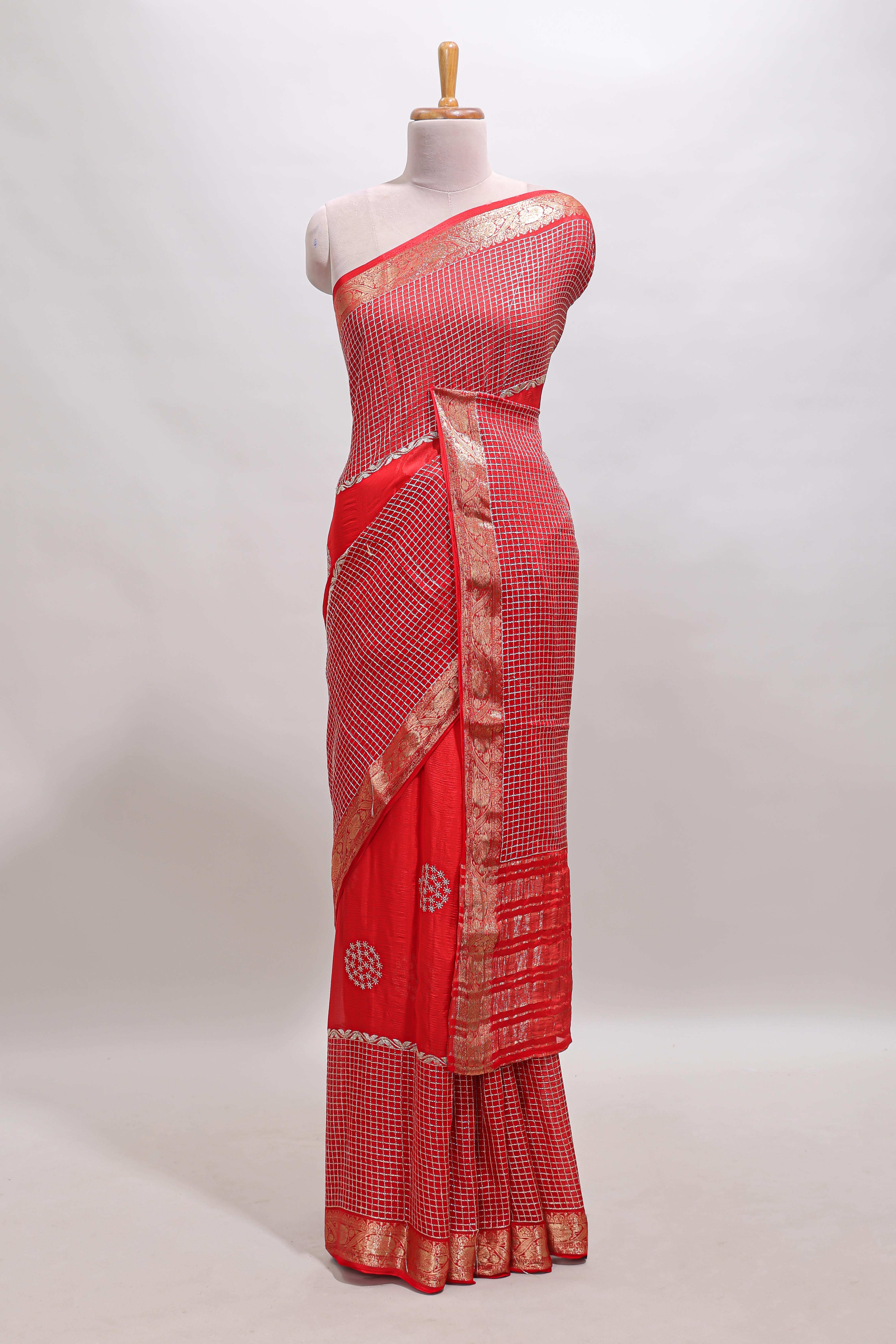 Red checked floral motifs chiffon saree with self zari border and contrast blouse