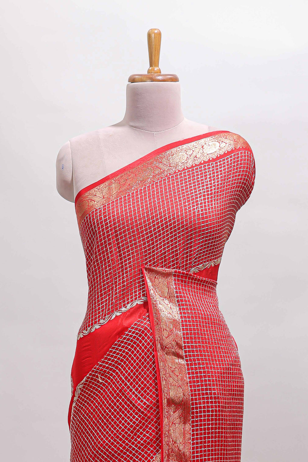 Red checked floral motifs chiffon saree with self zari border and contrast blouse