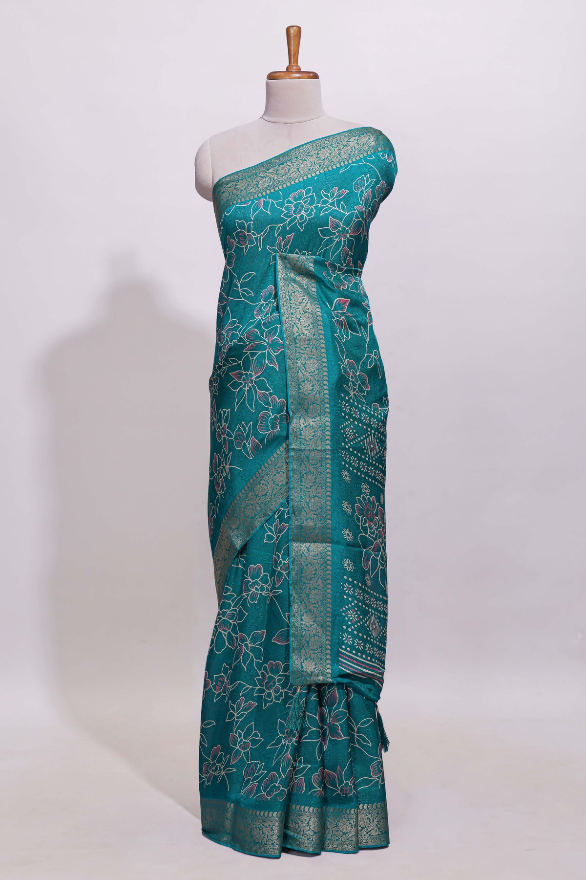 Teal green floral designed chiffon saree with self zari border and matching blouse