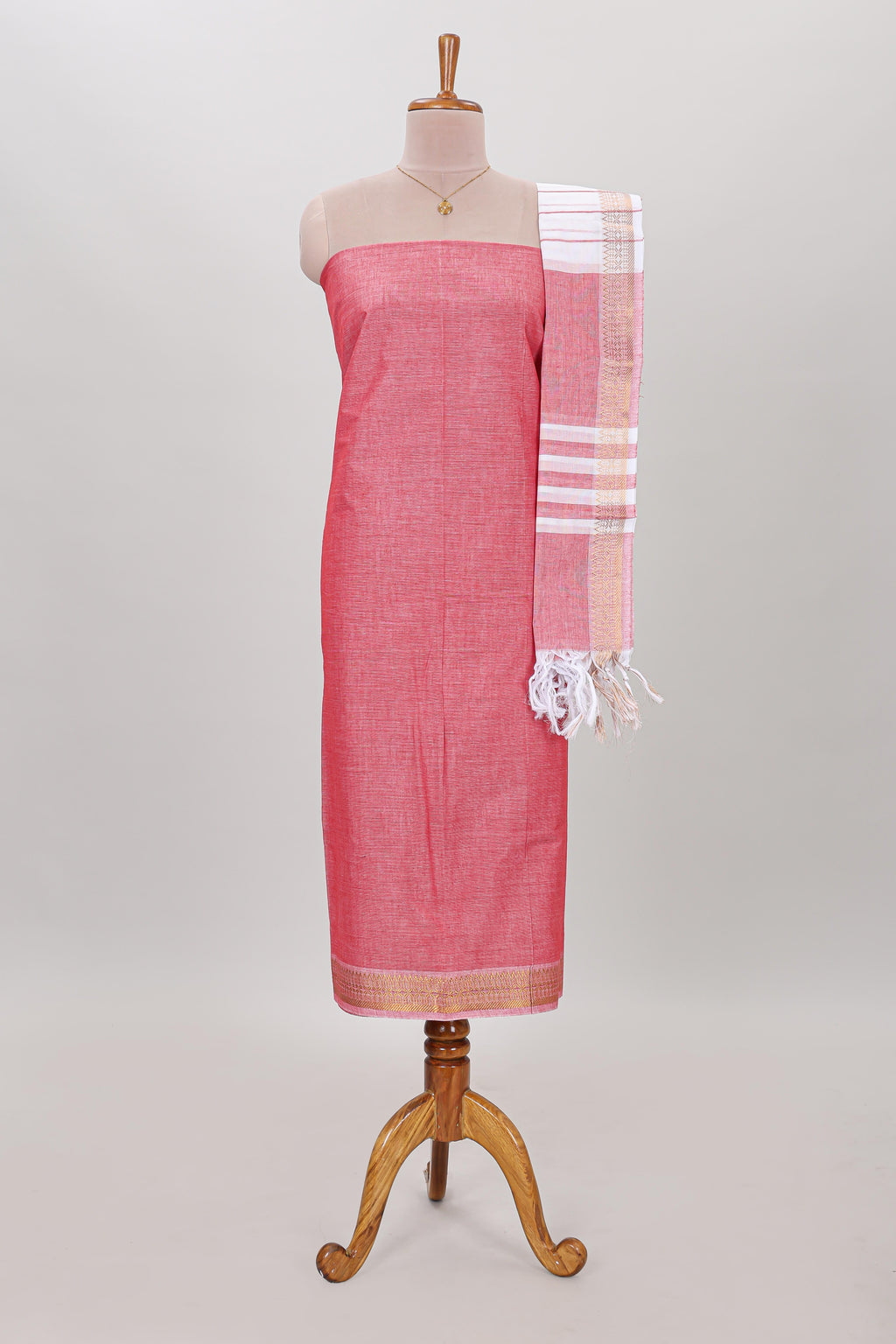 Peach plain cotton chudidhar material with contrast solid pant and matching striped dupatta