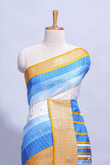 White and blue Dola Silk Saree with rich zari border woven butis and a designer pallu along with contrast blouse