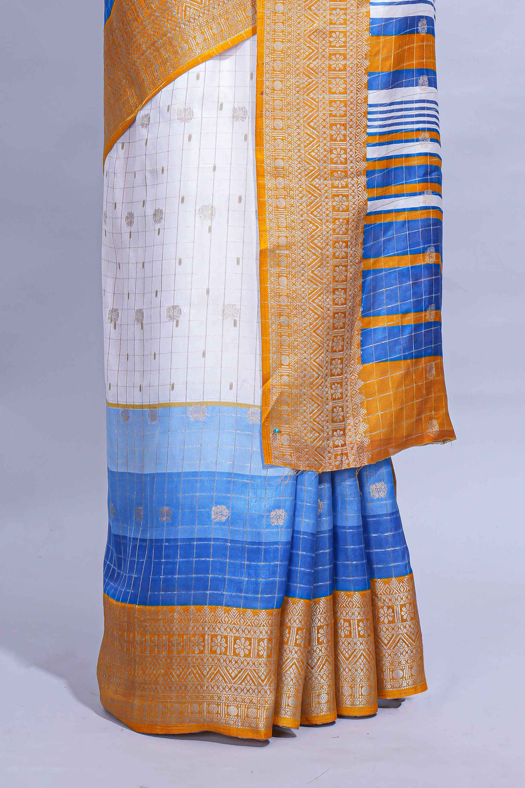 White and blue Dola Silk Saree with rich zari border woven butis and a designer pallu along with contrast blouse