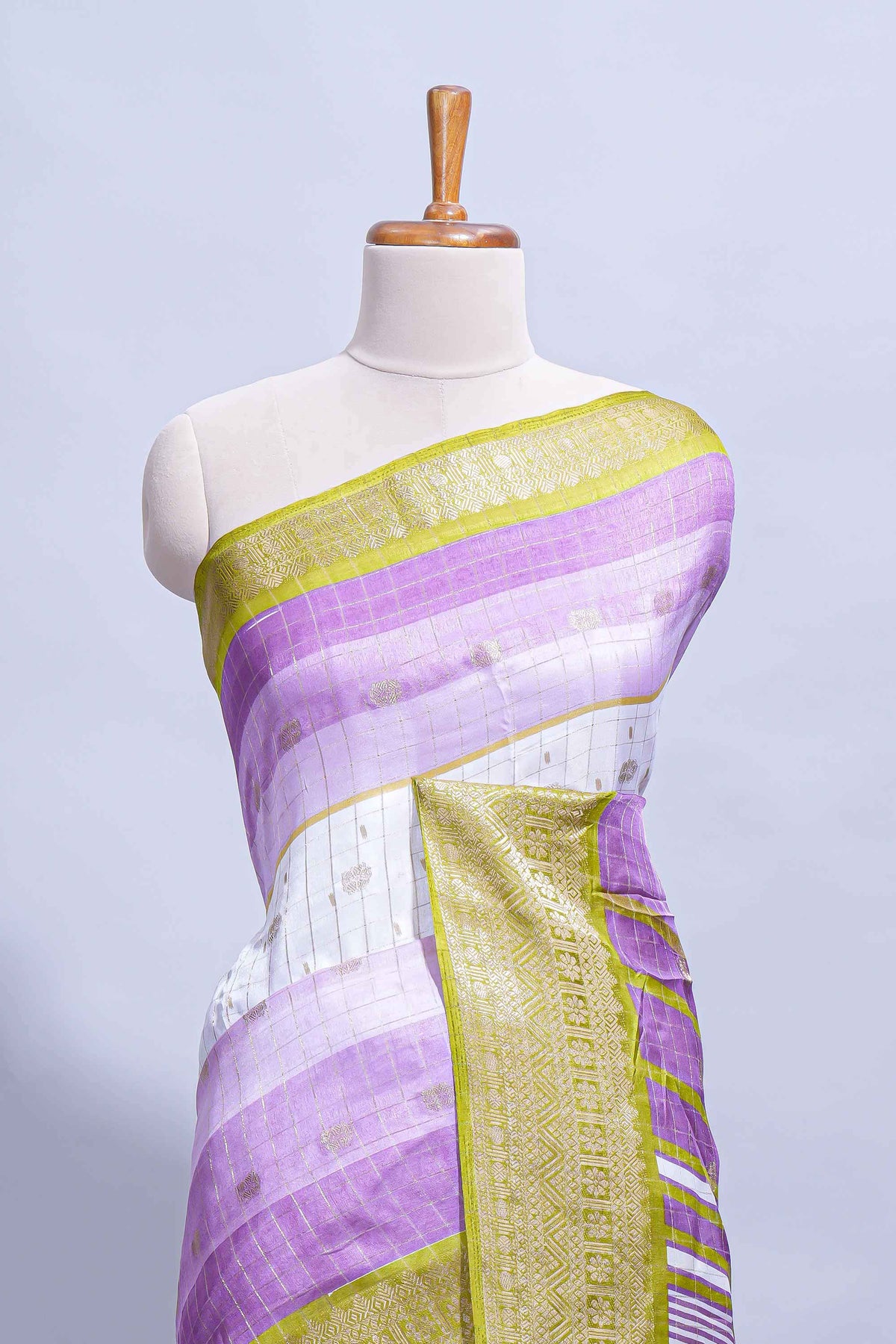 White and purple Dola Silk Saree with rich zari border woven butis and a designer pallu along with contrast blouse