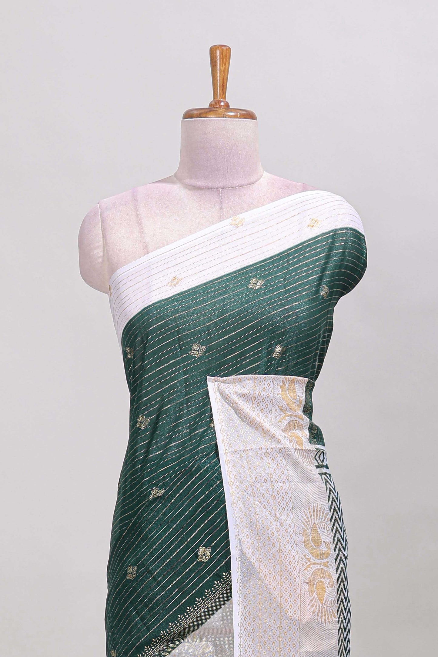 Green striped zari butta dola silk saree with contrast zari border and matching blouse