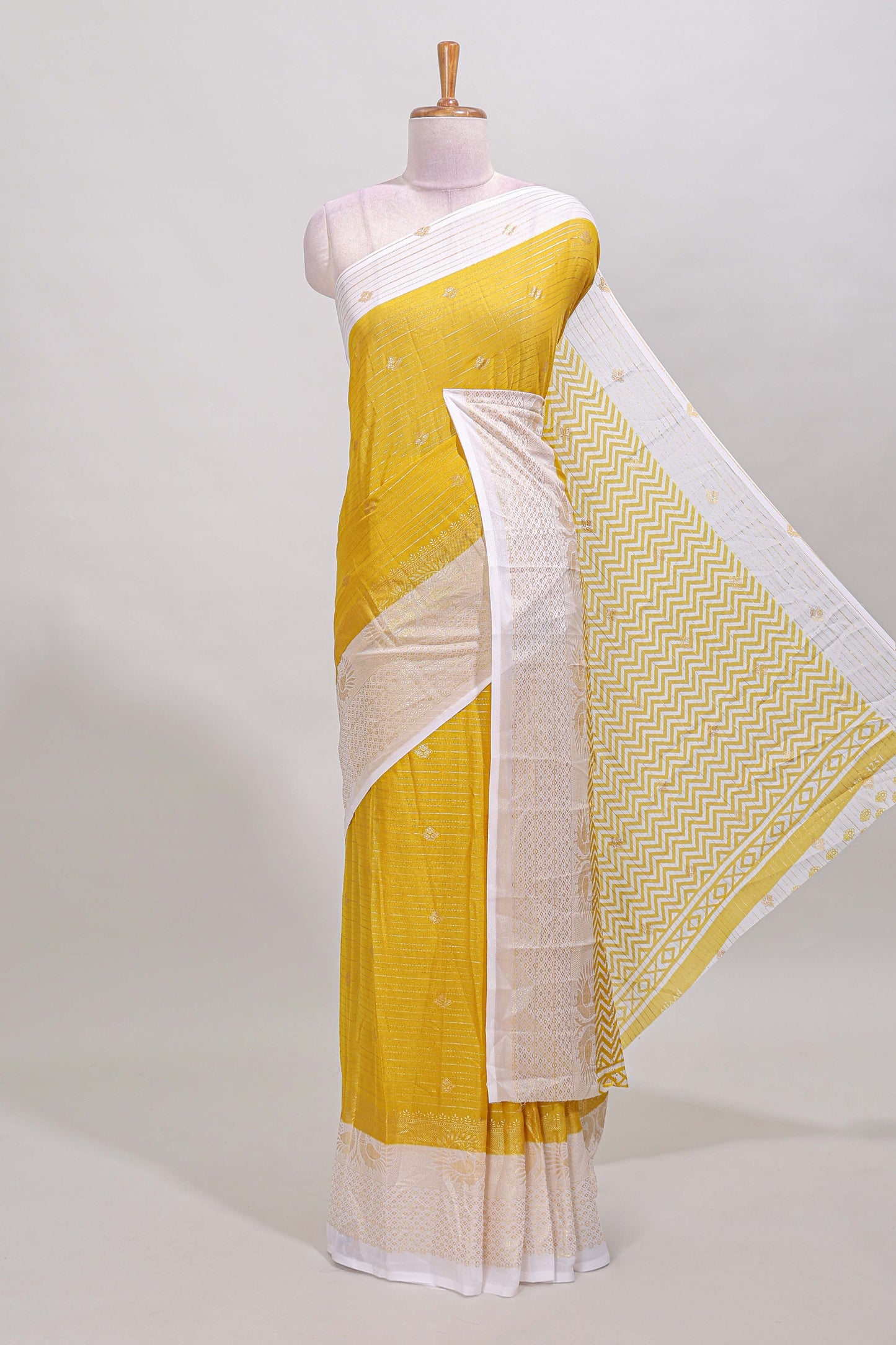 Yellow striped zari butta dola silk saree with contrast zari border and matching blouse